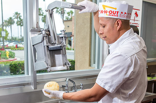 Associate cutting potatoes